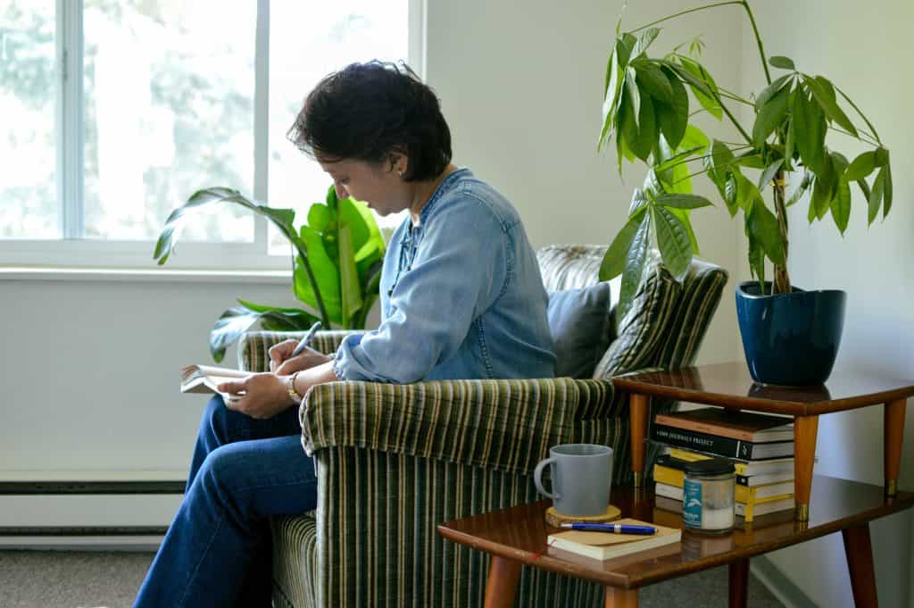 Karen writing in a journal.